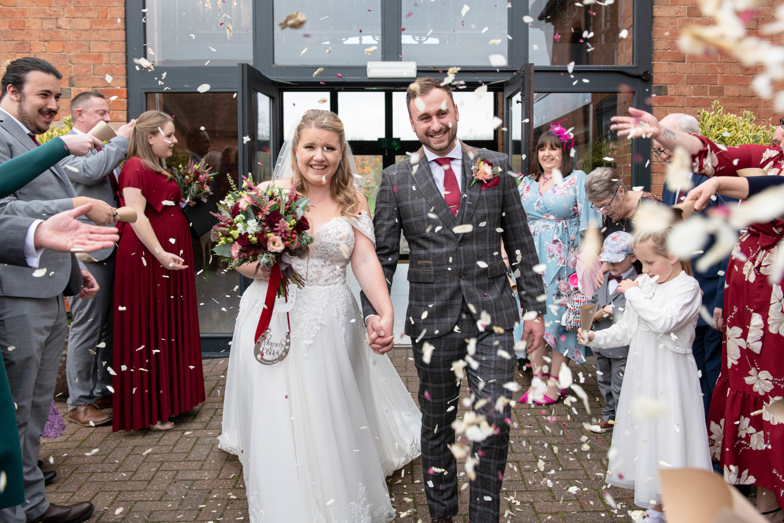 Confetti throw moment outside Meadow Barn