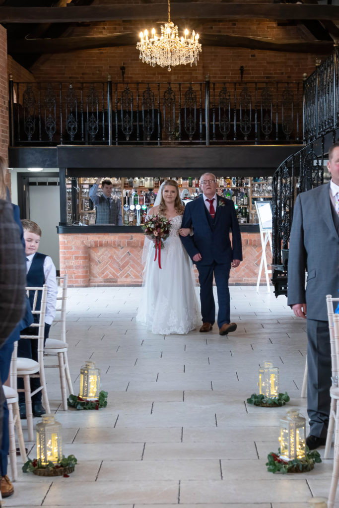 Bride walking down the aisle at Meadow Barn