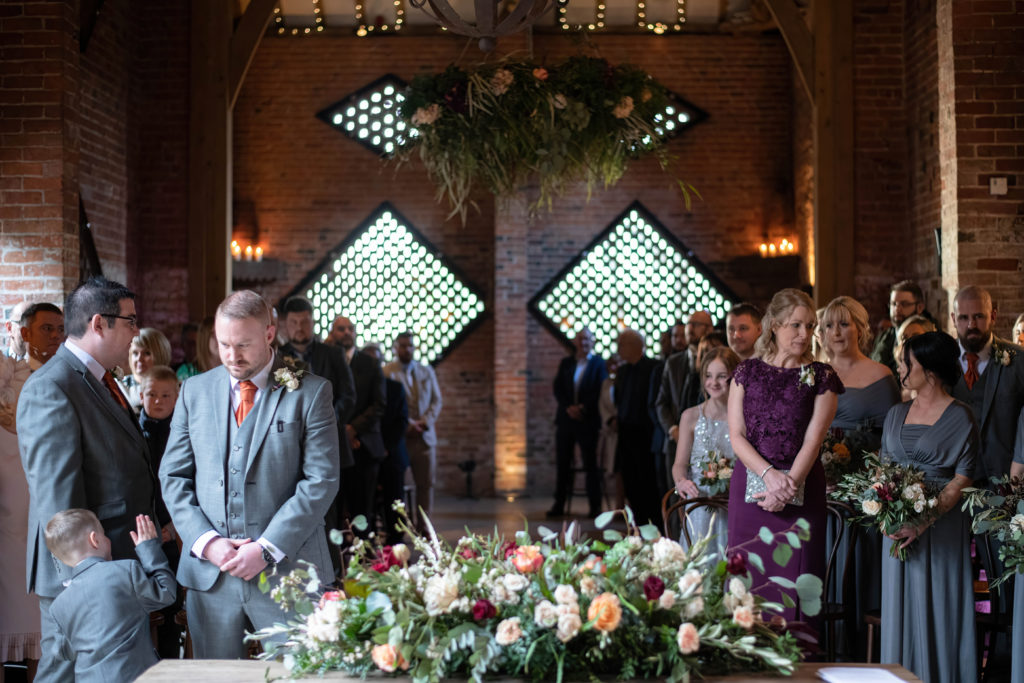 Groom nervously waiting for his bride to be to walk down the aisle