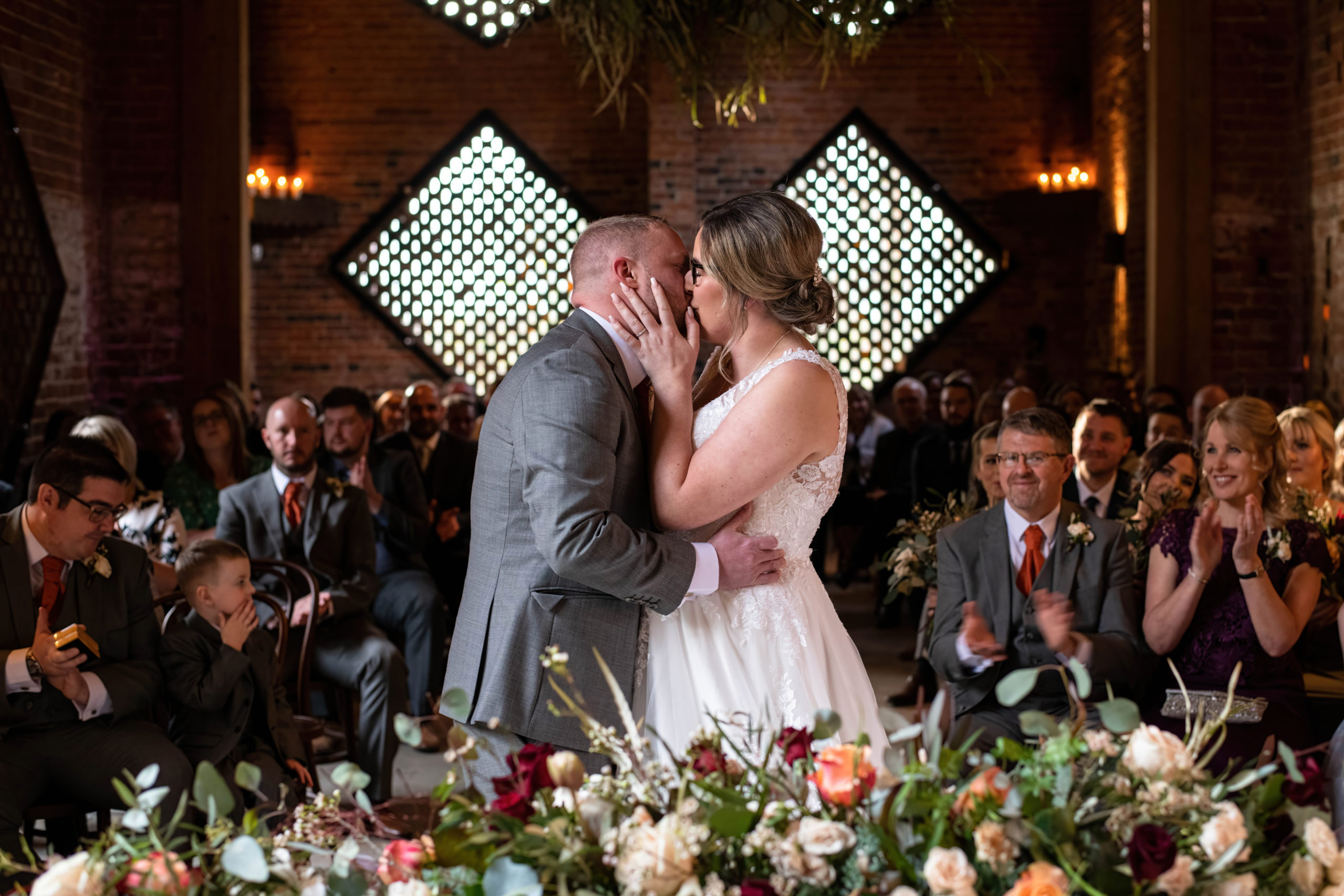 First kiss under fairy lights at Shustoke Barn